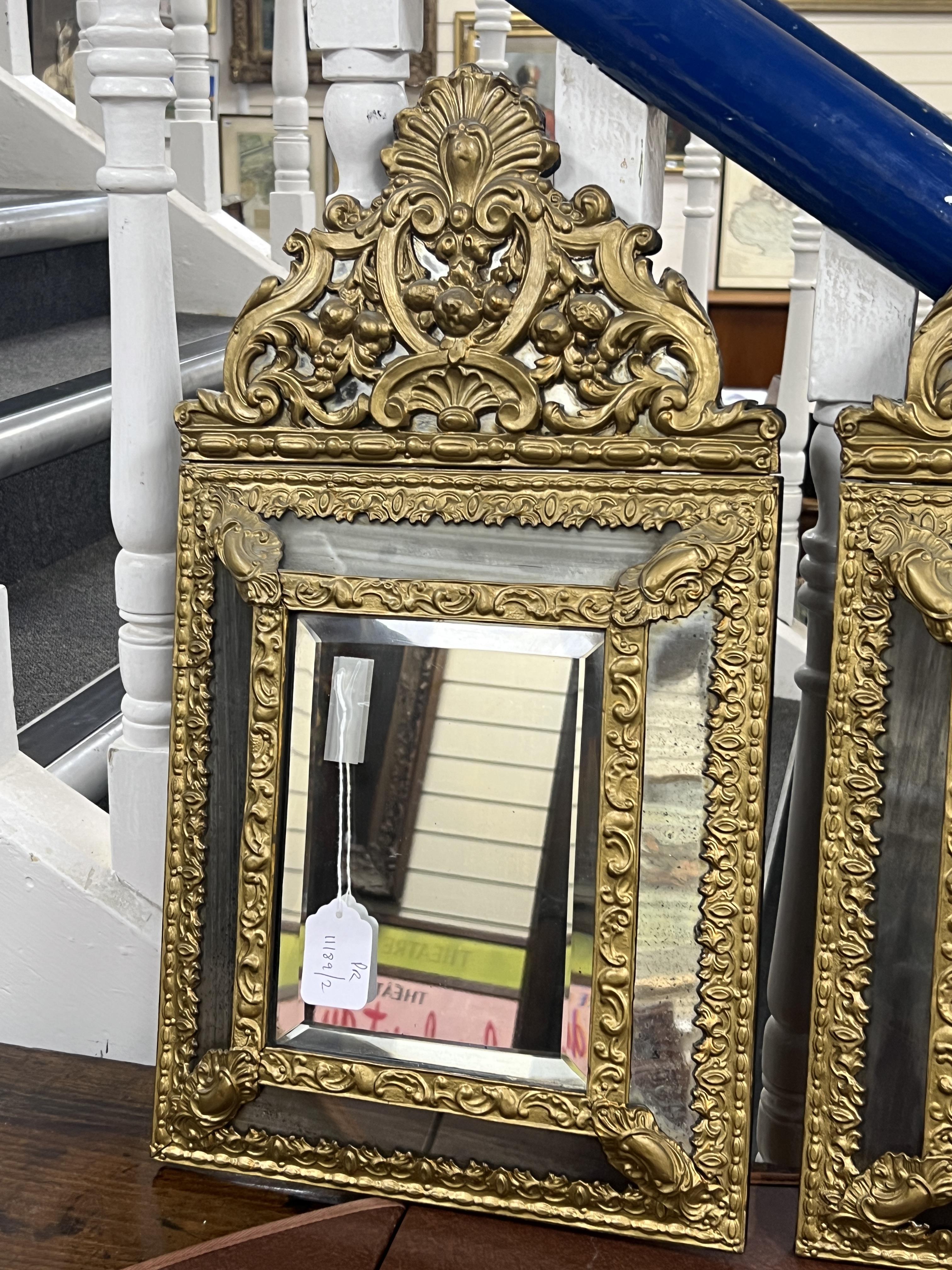 A pair of 19th century Dutch repousse wall mirrors, width 33cm, height 60cm